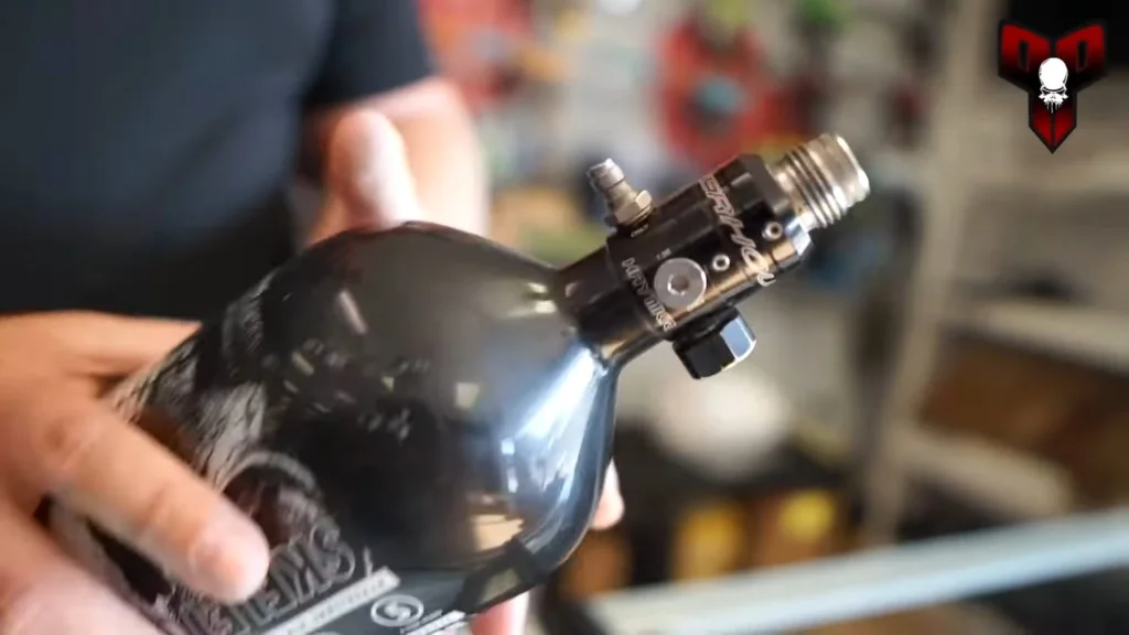 A scuba tank and fill station used to refill a paintball HPA tank