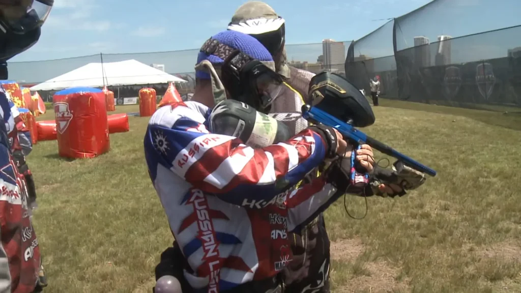 A player improving paintball gun accuracy on the field