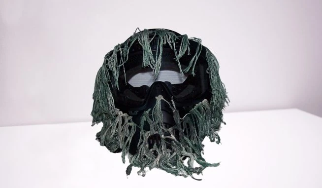 A customized ghillie-style paintball mask