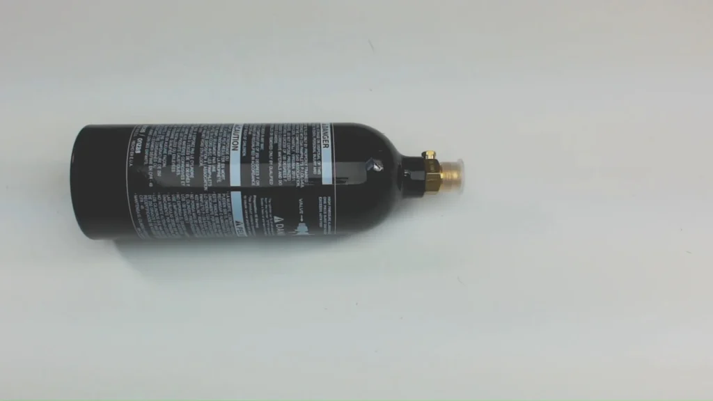 A paintball CO2 tank being safely emptied before disposal