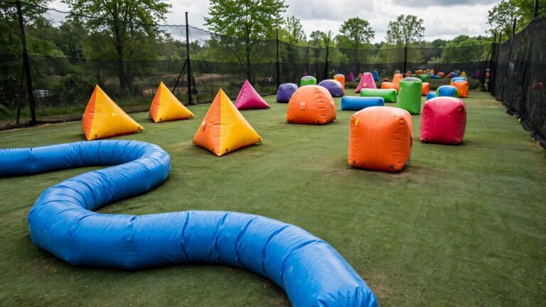 Speedball field dotted with colorful inflatable bunkers including a snake beam and doritos