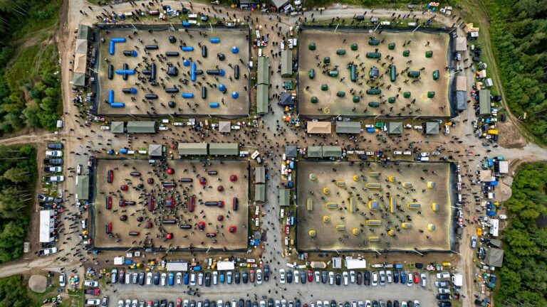 Aerial photograph of a large paintball tournament with hundreds of players across multiple fields